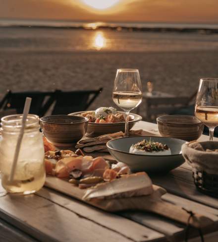Apéritif sur la plage de Châtelaillon-Plage au coucher du soleil, avec planche, thé glacé et vin blanc